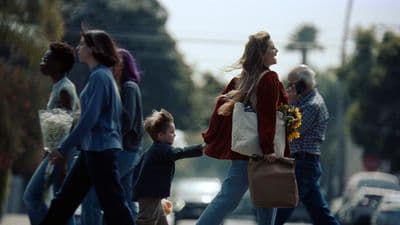 a group of people walking across a street