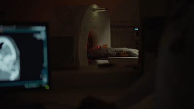 a person laying in a bed in a room