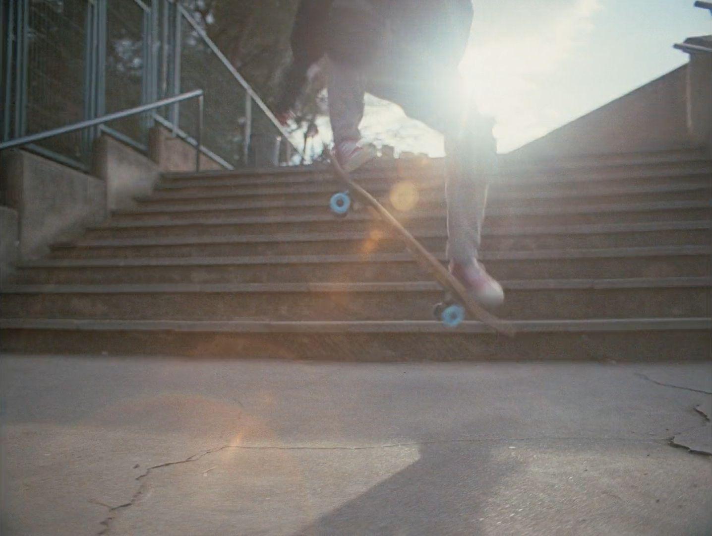 a person riding a skateboard down a flight of stairs