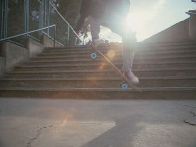 a person riding a skateboard down a flight of stairs
