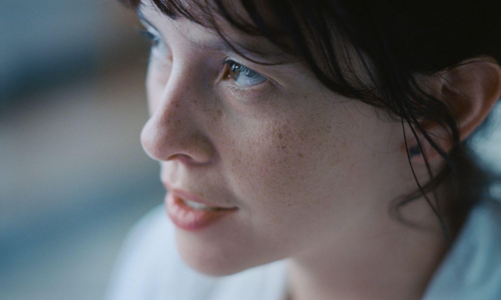 a close up of a woman with freckles on her face