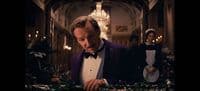 a man in a tuxedo standing in a room