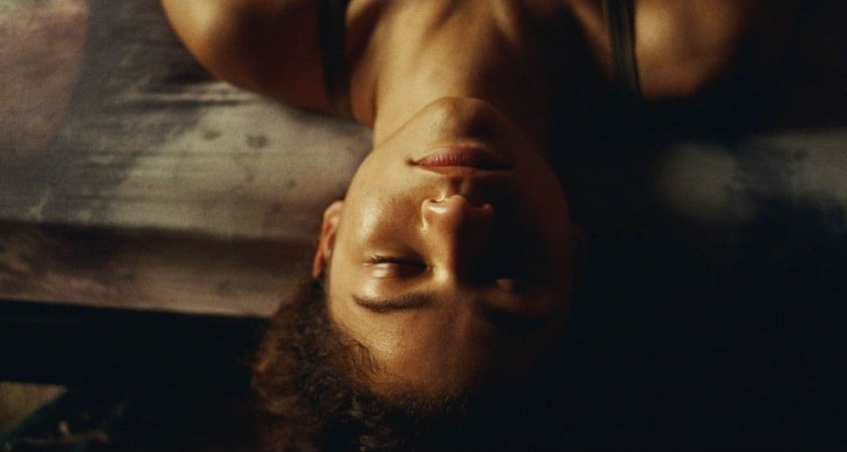 a man with a beard laying on a bed