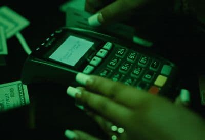 a person holding a cell phone in their hand