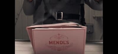 a man standing in front of a pink box