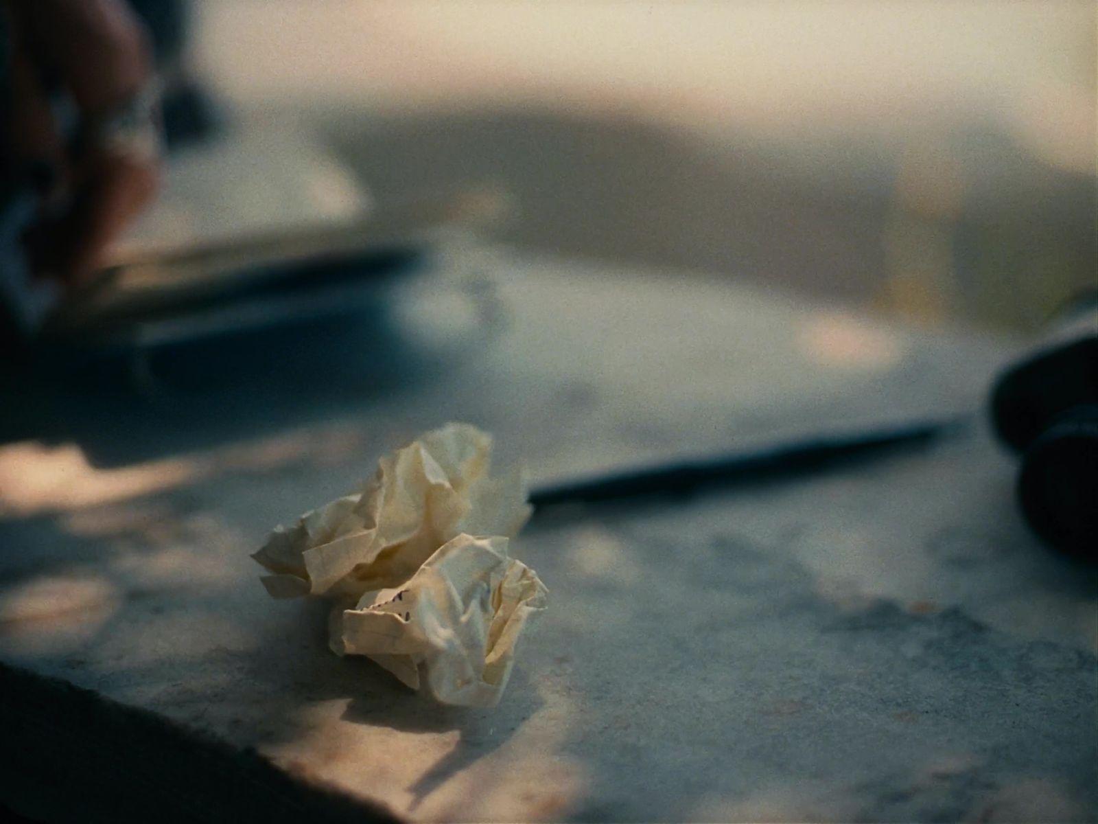 a crumpled piece of paper sitting on top of a table