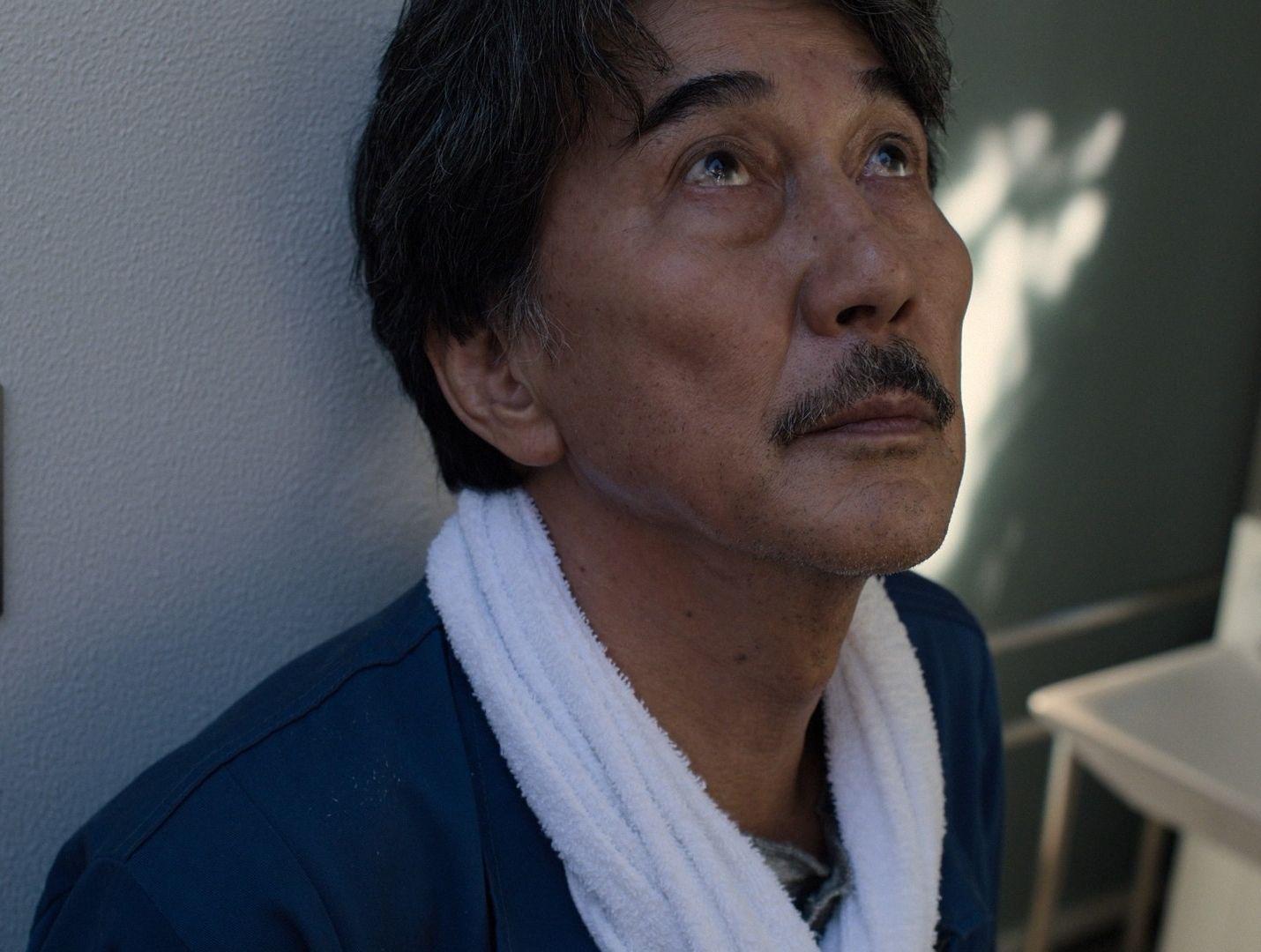 a man with a towel around his neck
