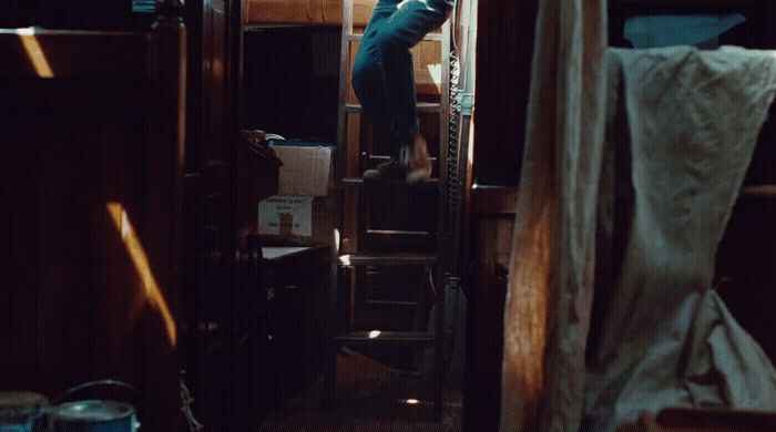 a person climbing up a ladder in a room