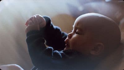 a close up of a baby holding a toy