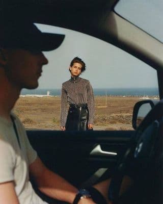 a man sitting in the drivers seat of a car