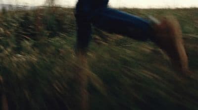 a blurry photo of a person in a field