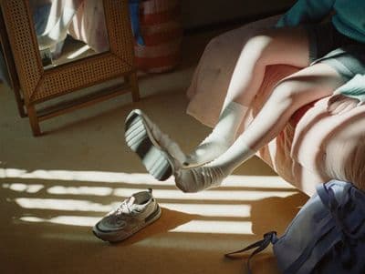 a person laying on the ground with their feet up