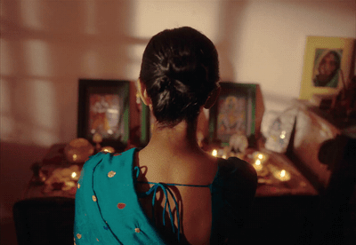 a woman standing in front of a table with candles