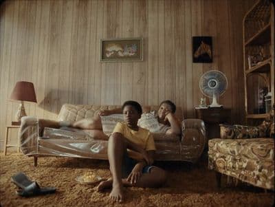 two people sitting on a couch in a living room