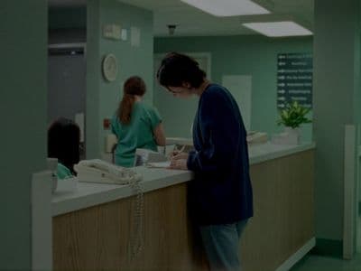 a woman standing at a counter in a hospital