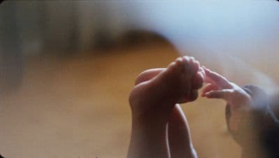 a couple of hands reaching for something in the air