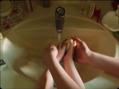 a person washing their hands in a sink