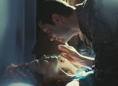 a man kissing a woman on the cheek