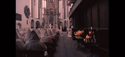 a large group of people sitting in a church