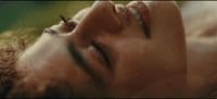 a woman laying down with her eyes closed