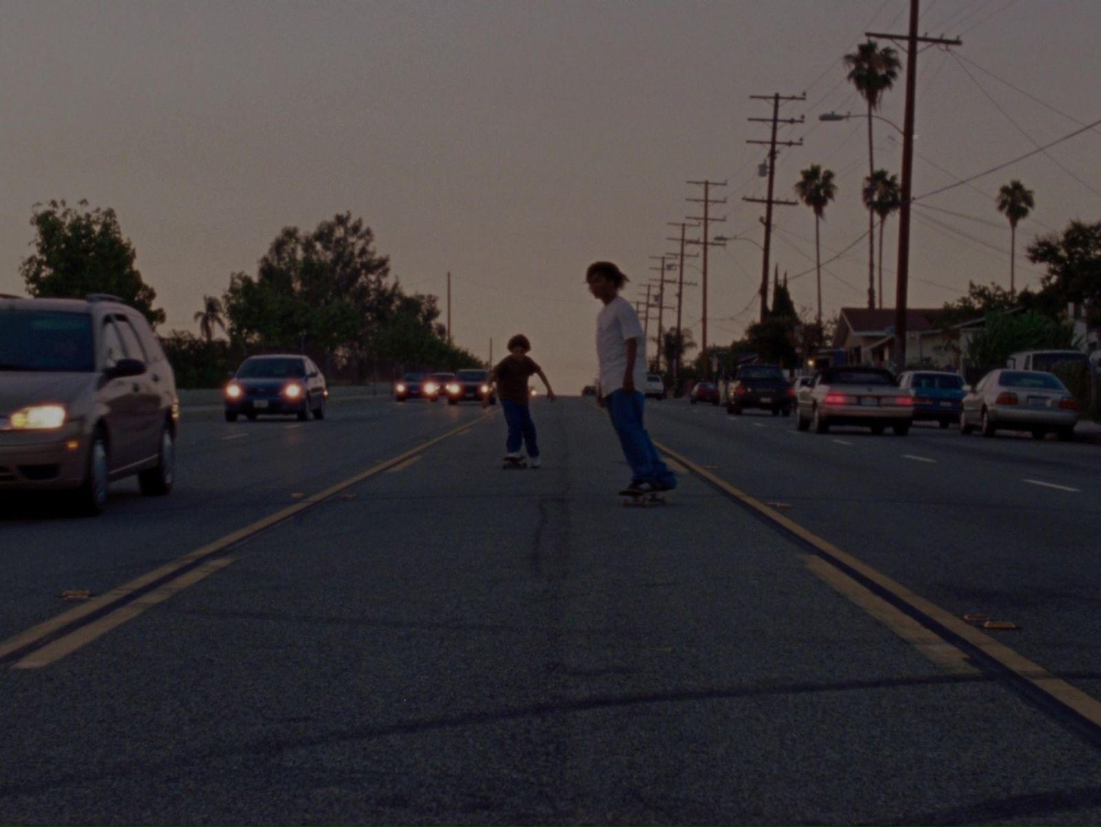 a man riding a skateboard down the middle of a street