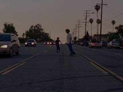 a man riding a skateboard down the middle of a street