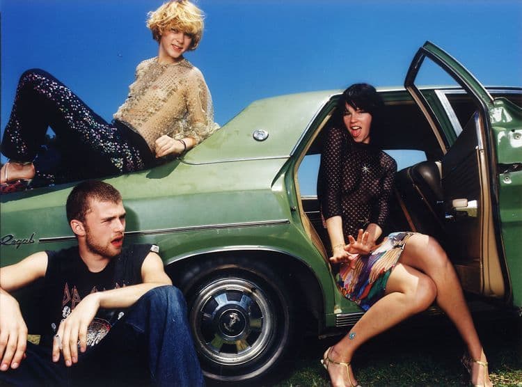 a group of people sitting in the back of a car