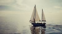 a sailboat floating in the middle of the ocean