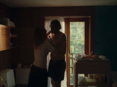 a man and a woman standing in front of a door
