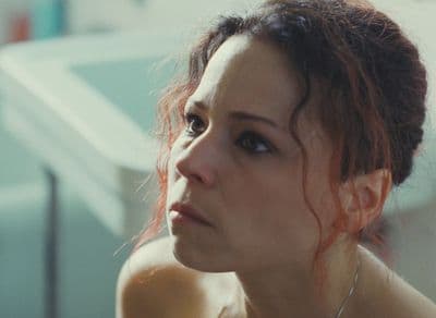 a close up of a person wearing a necklace
