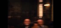 a blurry photo of two men in suits