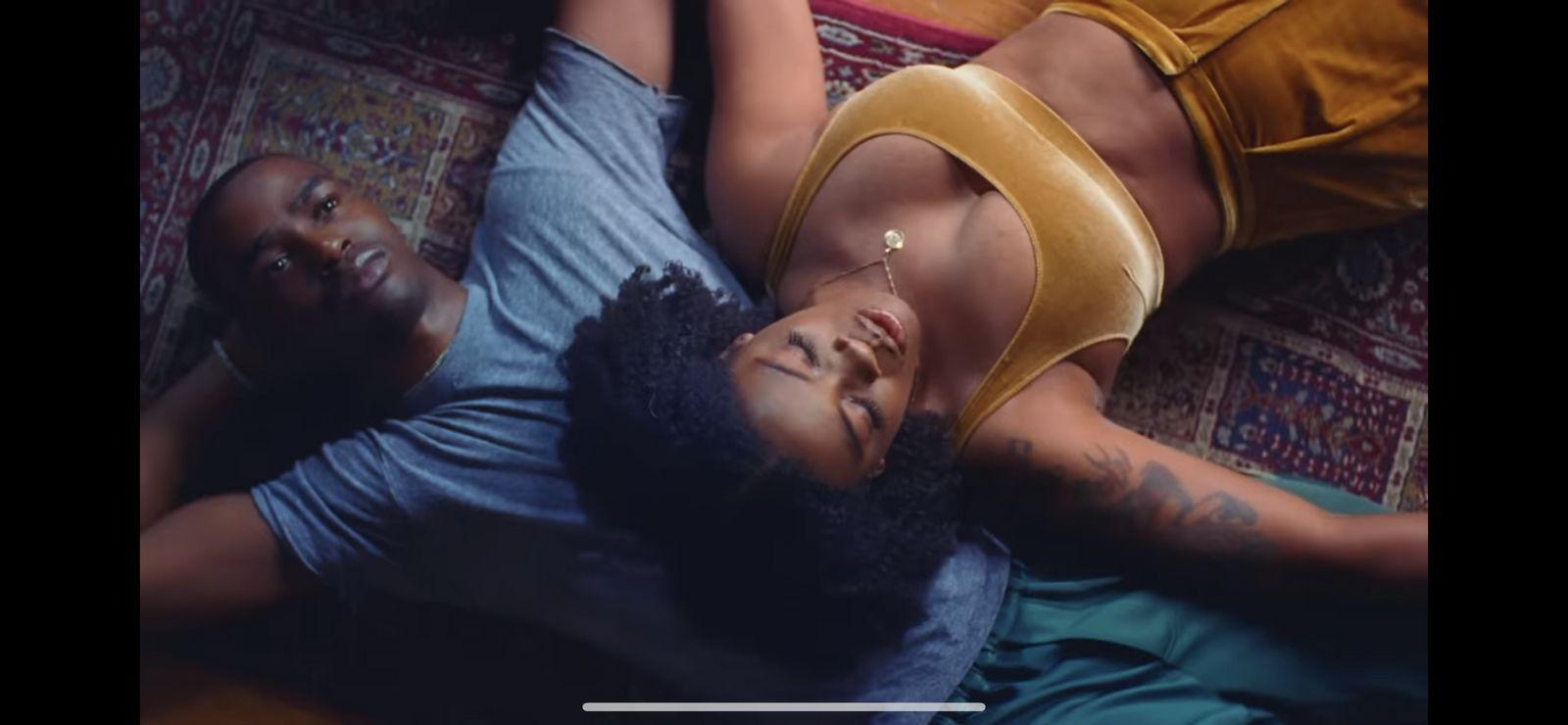 a couple of people laying on top of a couch