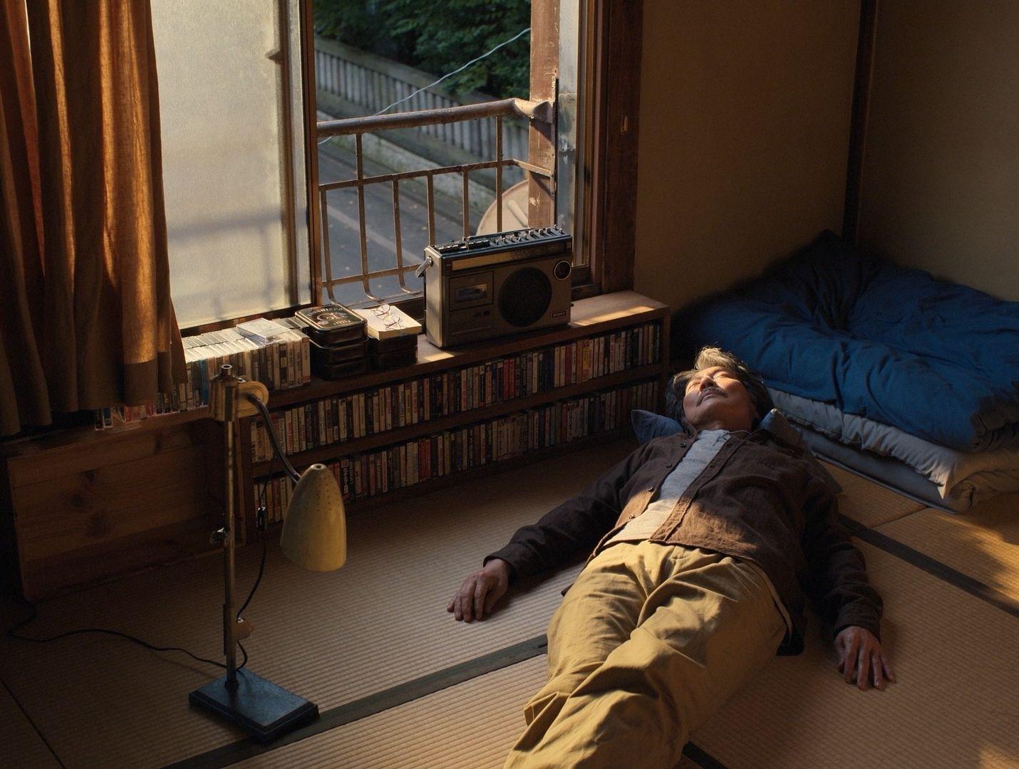 a man laying on the floor in front of a window