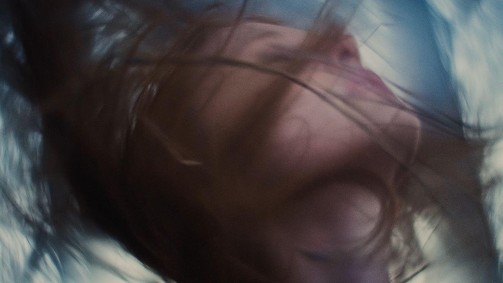 a blurry photo of a woman's face and hair