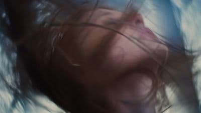a blurry photo of a woman's face and hair