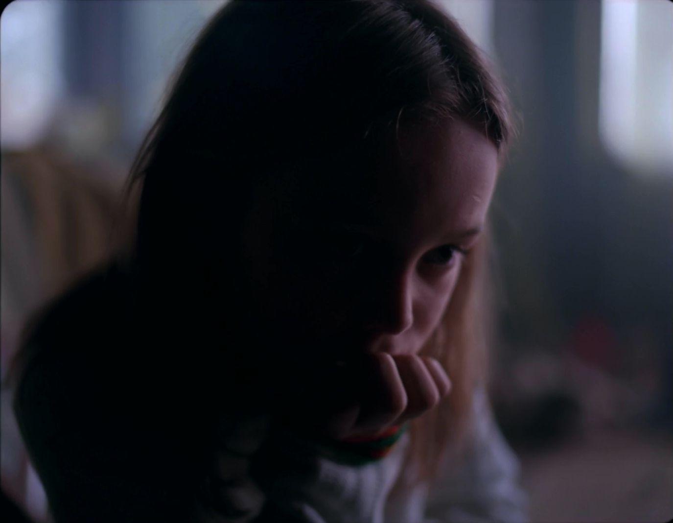 a young girl with a concerned look on her face