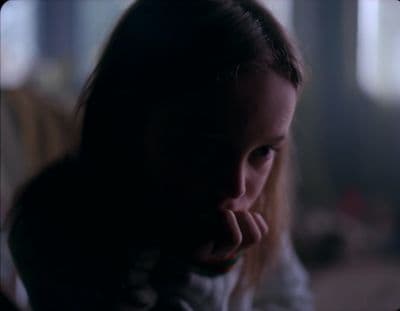 a young girl with a concerned look on her face
