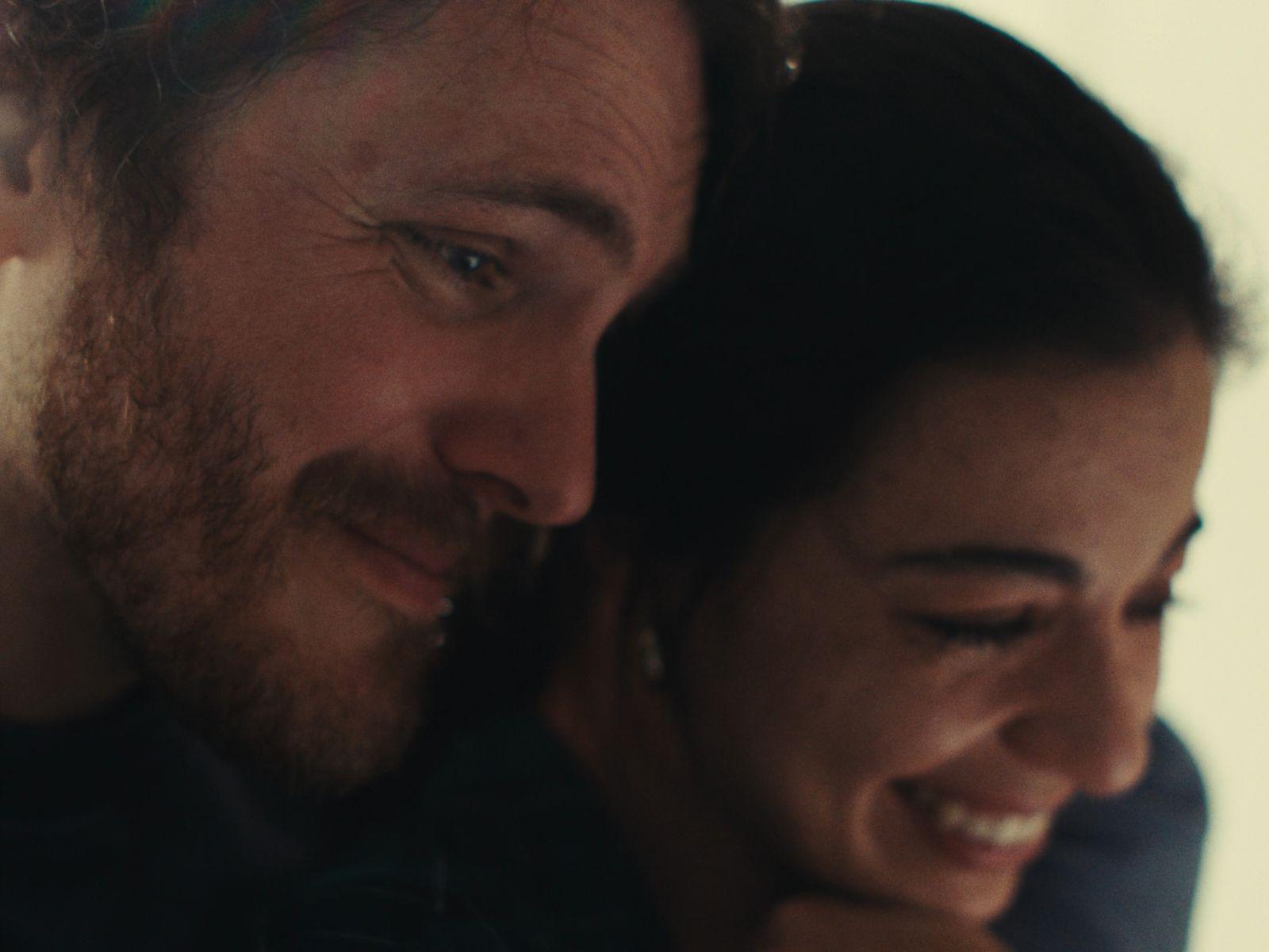 a man and a woman smiling at each other