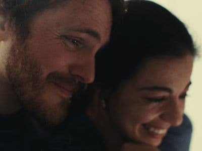 a man and a woman smiling at each other