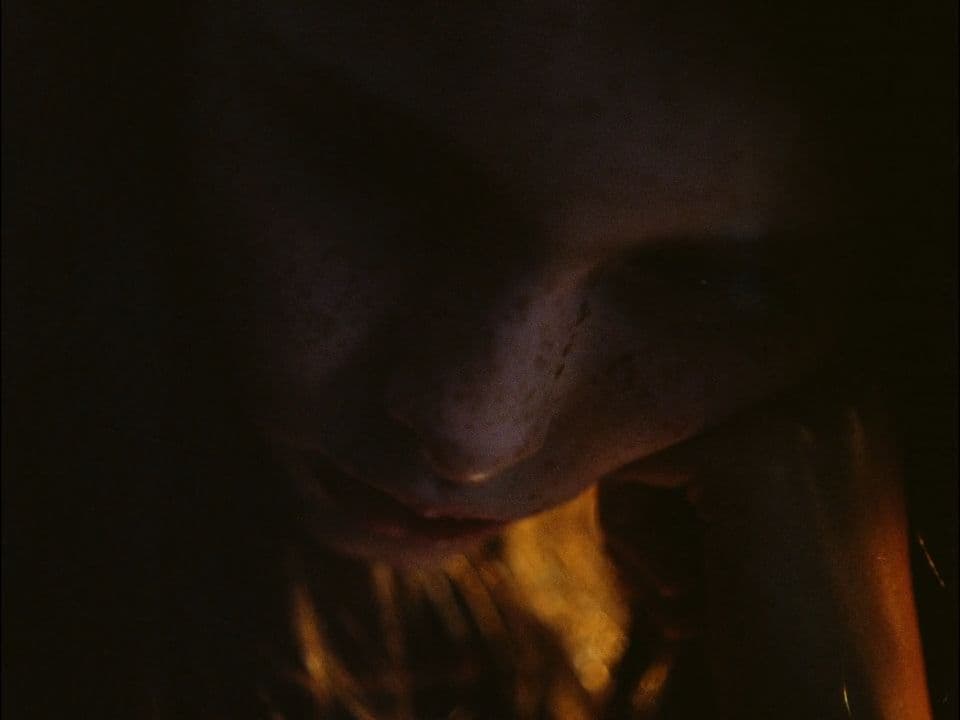a close up of a person's face in the dark
