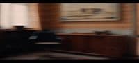 a blurry photo of a desk and chair in a room