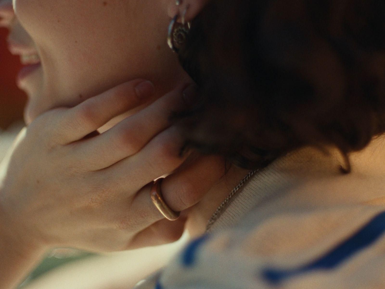a close up of a person wearing a ring