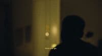 a person standing in a dark room with a light on