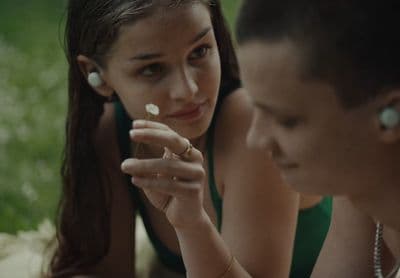 a girl and a boy are looking at something