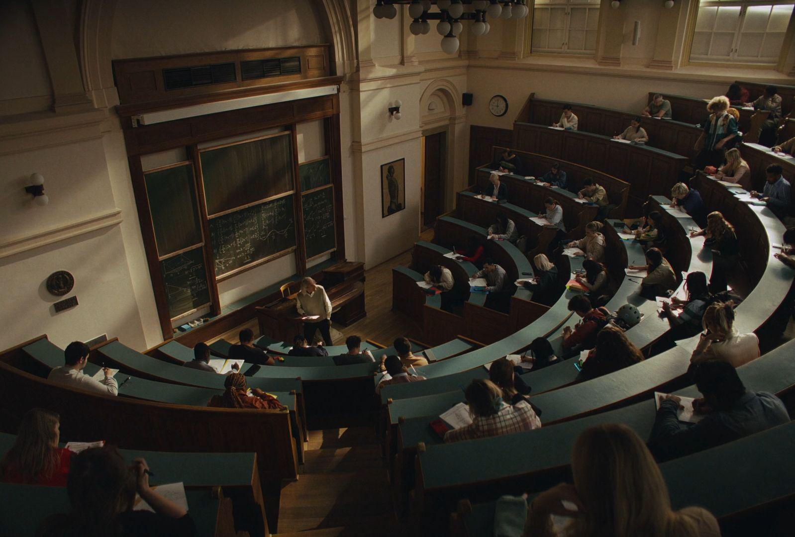 a group of people sitting in a lecture hall