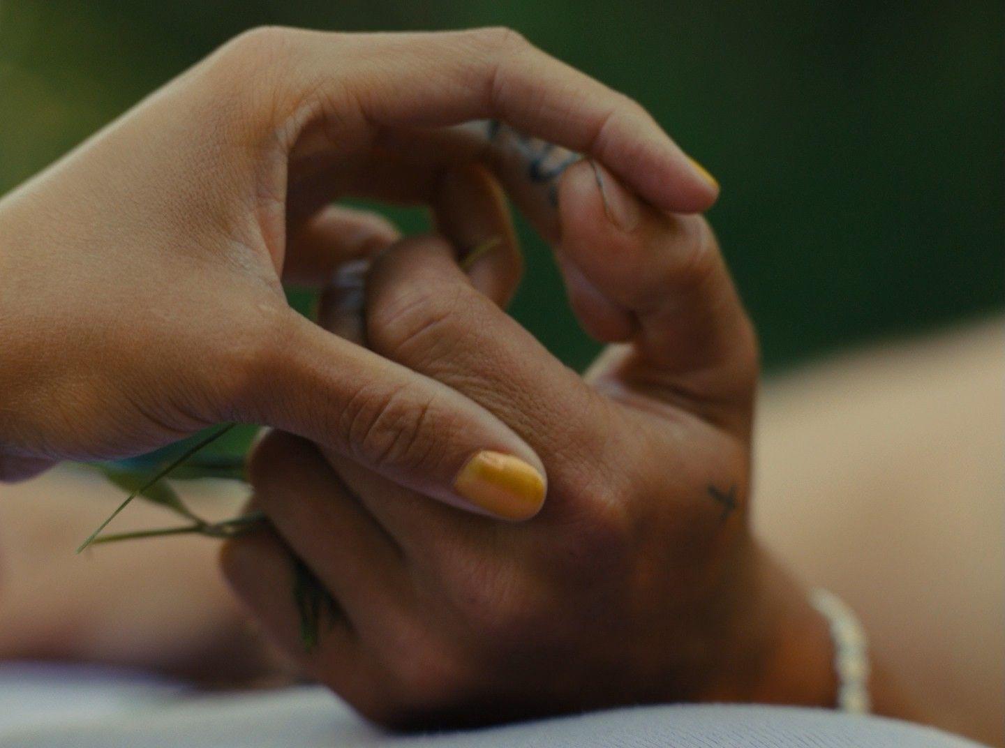 a close up of a person holding a flower