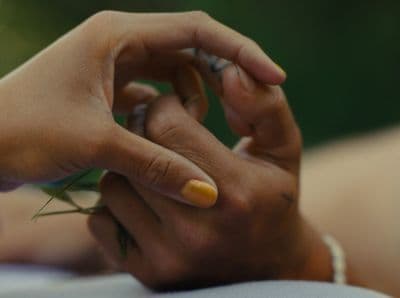 a close up of a person holding a flower