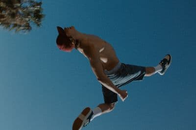 a man flying through the air while riding a skateboard