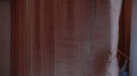 a blurry photo of a curtain with a cat on it