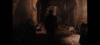 a man is walking through a dark tunnel
